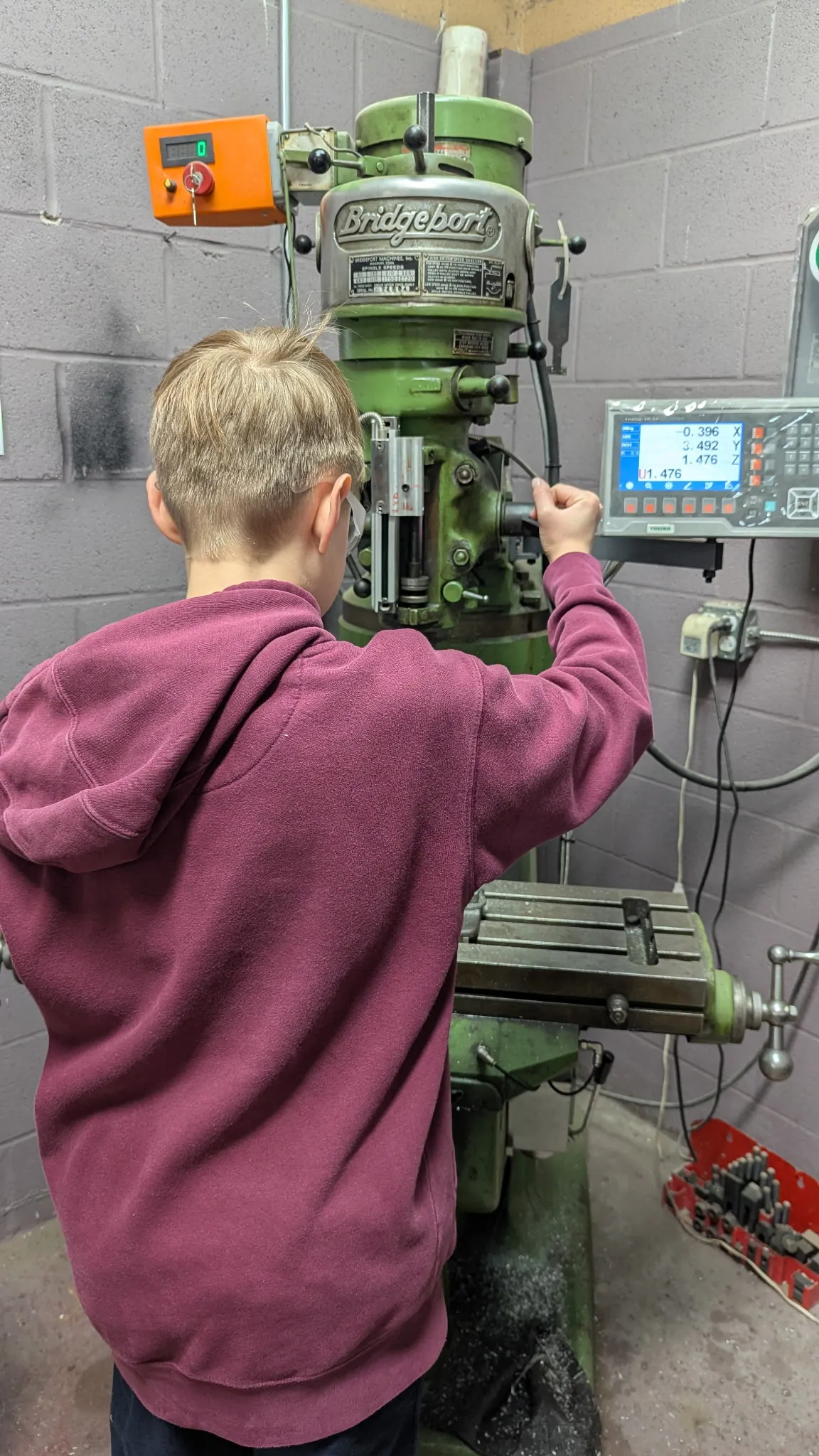 Student operating the Bridgeport knee mill