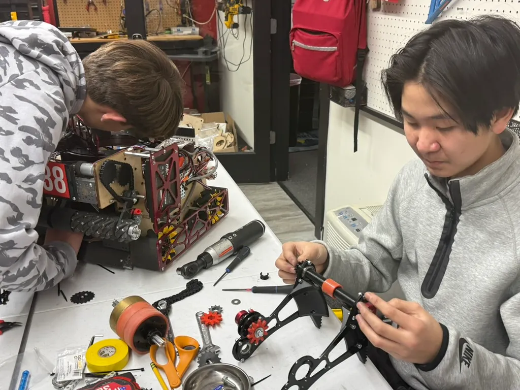 Students assembling robot mechanisms at FutureForward